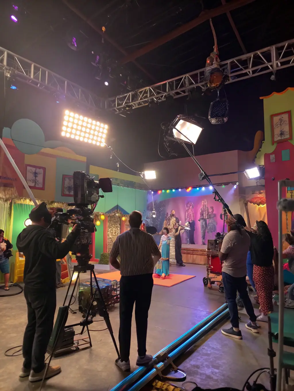 A vibrant promotional video shoot with dynamic visuals and engaging talent, highlighting the creative process of promotional content creation.
